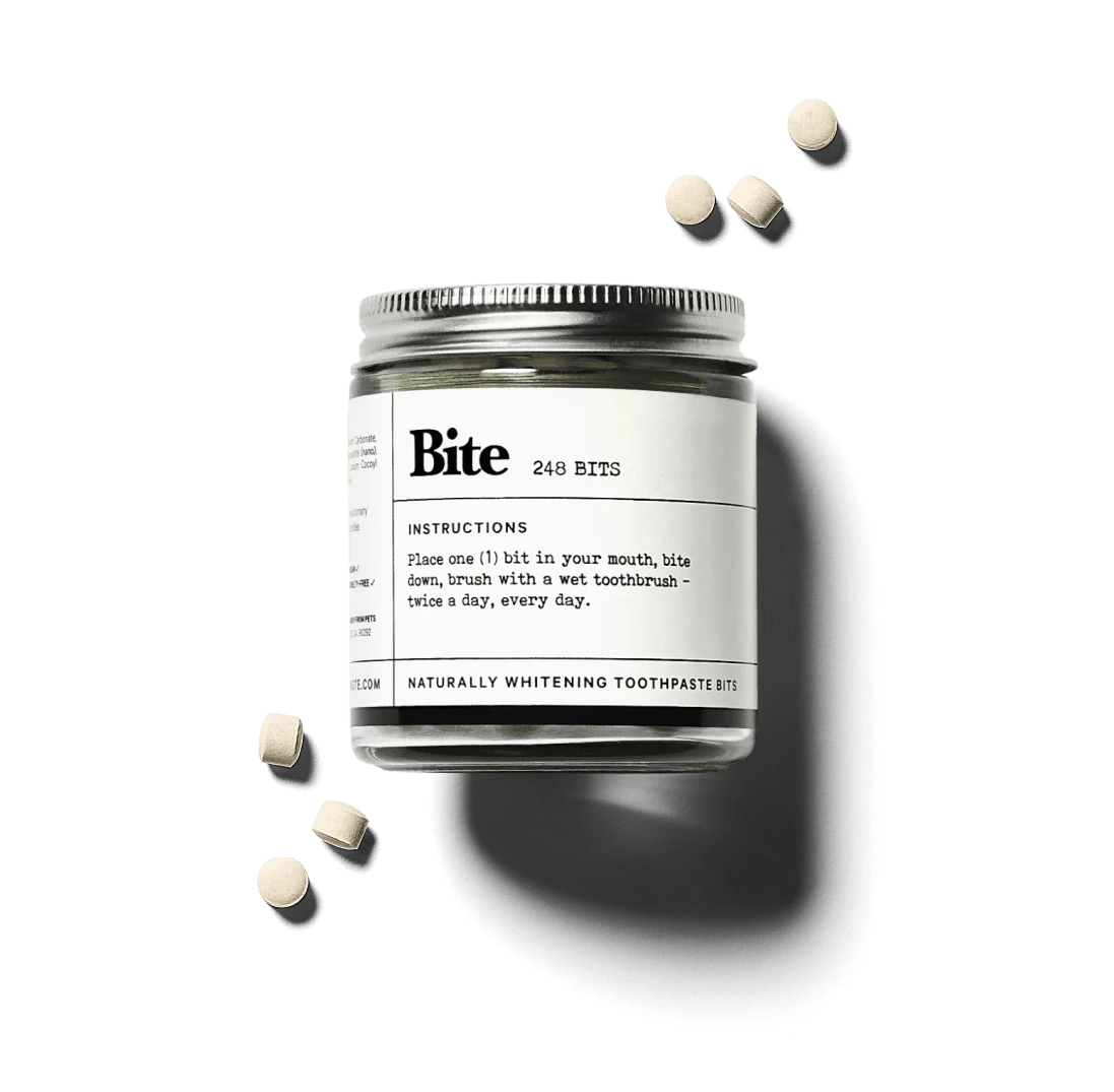 Toothpaste tablets, bamboo toothbrush, and packaging with 'detox from plastic' label.